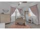 Cozy bedroom features a stylish four-poster bed, soft pink accents, and a charming, welcoming atmosphere at 25582 S 224Th Way, Queen Creek, AZ 85142