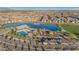 Aerial view of a neighborhood pool area next to a lake, playground, covered patios, and a parking lot at 25582 S 224Th Way, Queen Creek, AZ 85142