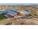 Aerial view of a neighborhood pool with shade and seating areas, a lake, and green space at 25582 S 224Th Way, Queen Creek, AZ 85142