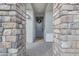 Covered front door featuring stone pillars and a decorative wreath on the front door at 25582 S 224Th Way, Queen Creek, AZ 85142