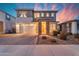 Inviting two-story home featuring a stone pillar entrance, a two car garage, and a beautiful paver driveway at 25582 S 224Th Way, Queen Creek, AZ 85142
