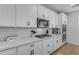 Modern kitchen boasts white cabinets, tile backsplash, and stainless steel appliances at 25582 S 224Th Way, Queen Creek, AZ 85142