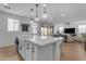 Bright kitchen features a center island with pendant lighting and stainless steel faucet at 25582 S 224Th Way, Queen Creek, AZ 85142