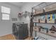 Well-organized laundry room with modern appliances, ample shelving, and efficient storage solutions at 25582 S 224Th Way, Queen Creek, AZ 85142