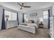 Bright main bedroom with a large bed, white furniture, and a ceiling fan for a cozy atmosphere at 25582 S 224Th Way, Queen Creek, AZ 85142