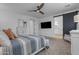 The main bedroom boasts modern black accents and a sleek TV mounted on the wall at 25582 S 224Th Way, Queen Creek, AZ 85142