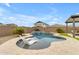 Lush backyard featuring a pool, travertine deck, tanning shelf, and manicured landscaping at 25582 S 224Th Way, Queen Creek, AZ 85142