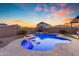 Backyard pool featuring a tanning ledge, beautiful landscaping, and a view of the neighborhood at 25582 S 224Th Way, Queen Creek, AZ 85142