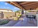 Backyard featuring desert landscaping, a rock water feature, and a covered patio at 2630 N El Dorado Pl, Chandler, AZ 85224