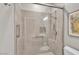 Bathroom featuring a glass-enclosed shower with a showerhead, a grab bar, and tile walls at 2630 N El Dorado Pl, Chandler, AZ 85224