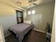 Cozy bedroom features neutral walls, a patterned bedspread, and a large window at 2821 S Skyline Dr # 134, Mesa, AZ 85212