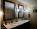 A spacious bathroom with dual sinks, framed mirrors and ample lighting at 3030 N Hayden Rd # 28, Scottsdale, AZ 85251