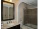 Bathroom featuring marble countertop, updated fixtures, and tiled shower with glass doors at 3030 N Hayden Rd # 28, Scottsdale, AZ 85251