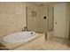 Spa-like bathroom featuring a modern tub, a glass enclosed shower and beautiful tile work at 3030 N Hayden Rd # 28, Scottsdale, AZ 85251