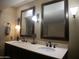 Bathroom featuring double sinks with bronze fixtures and decorative mirrors at 3030 N Hayden Rd # 28, Scottsdale, AZ 85251