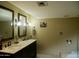 A well-lit bathroom features dual vanities, framed mirrors and neutral wall color at 3030 N Hayden Rd # 28, Scottsdale, AZ 85251