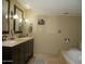 Bathroom showcasing a double sink vanity with updated fixtures, and a separate soaking tub at 3030 N Hayden Rd # 28, Scottsdale, AZ 85251