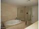 Bathroom showcasing tiled walls, a soaking tub, and a separate glass shower at 3030 N Hayden Rd # 28, Scottsdale, AZ 85251