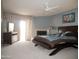 Large carpeted bedroom with ceiling fan, fireplace, and sliding glass door to the exterior at 3030 N Hayden Rd # 28, Scottsdale, AZ 85251