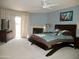 Large carpeted bedroom with ceiling fan, fireplace, and sliding glass door to the exterior at 3030 N Hayden Rd # 28, Scottsdale, AZ 85251