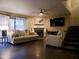 Bright living room featuring a fireplace, comfortable seating, and a modern ceiling fan at 3030 N Hayden Rd # 28, Scottsdale, AZ 85251