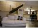 Open living room with comfortable seating, a view into the kitchen, and a modern staircase at 3030 N Hayden Rd # 28, Scottsdale, AZ 85251