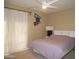 Cozy bedroom features a ceiling fan, a king size bed and decorated wall art at 3030 N Hayden Rd # 28, Scottsdale, AZ 85251