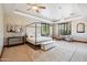 Elegant main bedroom with tray ceiling, plantation shutters, and plenty of natural light at 3317 E Mcdowell Rd, Mesa, AZ 85213