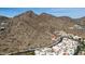 Majestic aerial view of desert residences nestled against a backdrop of rugged mountains and clear sky at 3800 E Lincoln Dr # 7, Phoenix, AZ 85018