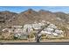Scenic aerial view of a mountainside community boasting Southwestern architecture and desert landscaping at 3800 E Lincoln Dr # 7, Phoenix, AZ 85018