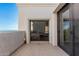 Private balcony featuring tile flooring, white stucco and sliding glass door at 3800 E Lincoln Dr # 7, Phoenix, AZ 85018