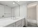 Bright bathroom featuring a white vanity and views of the toilet and shower at 3800 E Lincoln Dr # 7, Phoenix, AZ 85018