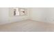 Bright bedroom with neutral carpet, shuttered windows, and a serene atmosphere at 3800 E Lincoln Dr # 7, Phoenix, AZ 85018