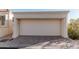 Attached one car garage features a light colored door at 3800 E Lincoln Dr # 7, Phoenix, AZ 85018