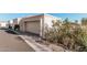 Attached garage with a light colored door and desert landscaping at 3800 E Lincoln Dr # 7, Phoenix, AZ 85018