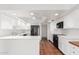 Kitchen featuring white cabinets, a black refrigerator and terracotta tile floors at 3800 E Lincoln Dr # 7, Phoenix, AZ 85018