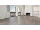 Bright living room with a fireplace, hardwood floors, and access to an outside view at 3800 E Lincoln Dr # 7, Phoenix, AZ 85018