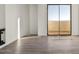 Bright room featuring hardwood floors, a large window, and access to outside view at 3800 E Lincoln Dr # 7, Phoenix, AZ 85018