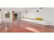 Spacious living room with gleaming hardwood floors, custom bench seating, and natural light at 3800 E Lincoln Dr # 7, Phoenix, AZ 85018