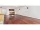 Spacious living room with custom built-in bar area and gleaming hardwood floors at 3800 E Lincoln Dr # 7, Phoenix, AZ 85018