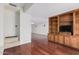 Open-concept living area featuring hardwood floors, built-in shelving and a cozy atmosphere at 3800 E Lincoln Dr # 7, Phoenix, AZ 85018