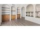 Open-concept living area with hardwood floors, built-in shelves, and elegant architectural details at 3800 E Lincoln Dr # 7, Phoenix, AZ 85018
