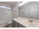 Well-lit bathroom features a shower-tub combo, a gray vanity, and a large mirror at 3917 E Morenci Rd, San Tan Valley, AZ 85143