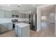 Stylish kitchen features gray cabinets, stainless steel appliances, and an island with white countertops at 3917 E Morenci Rd, San Tan Valley, AZ 85143