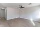 Spacious living room with light wood floors and a modern ceiling fan, perfect for entertaining or relaxing at 3917 E Morenci Rd, San Tan Valley, AZ 85143