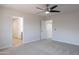 Open floor plan features plush carpeting and doorways leading to other rooms of the house at 3917 E Morenci Rd, San Tan Valley, AZ 85143