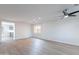 Spacious living room featuring wood-look flooring, recessed lighting, and a view of the modern kitchen at 3917 E Morenci Rd, San Tan Valley, AZ 85143