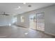 Light-filled living room features wood floors, a ceiling fan, and sliding glass doors to the backyard at 3917 E Morenci Rd, San Tan Valley, AZ 85143