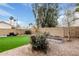 Desert landscaped backyard with artificial turf grass, a low block wall, and minimal plant life at 4013 E Woodland Dr, Phoenix, AZ 85048