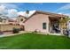Backyard with well-maintained green turf, desert landscaping and a covered patio that's great for relaxing at 4013 E Woodland Dr, Phoenix, AZ 85048